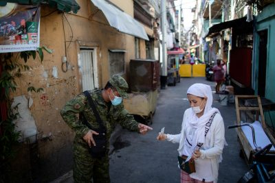 A soldier wearing a protective mask checks a woman's quarantine pass as the city undergoes a stricter lockdown to contain the coronavirus disease (COVID-19) spread, in Pasay City, Philippines, 22 April 2020 (Photo: Reuters/Eloisa Lopez). A soldier wearing a protective mask checks a woman’s quarantine pass as the city undergoes a stricter lockdown to contain the coronavirus disease (COVID-19) spread, in Pasay City, Philippines, 22 April 2020 (Photo: Reuters/Eloisa Lopez).