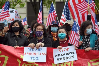 People holding American flags and anti-hate signs, New York, 2 May 2021 (Photo: Reuters/Anthony Behar). People holding American flags and anti-hate signs, New York, 2 May 2021 (Photo: Reuters/Anthony Behar).