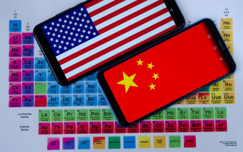 The photo of USA and China flags on of smartphones which are laying on the periodic table around the groups of rare earth minerals. Conceptual. Image Alamy ContributorAscannio. Image ID2A3HRMR China-US critical minerals war an opportunity for Australia to get smart