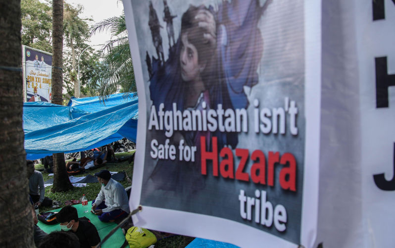 Afghan refugee men living in Indonesia sit in their tent during a protest with the night outside the UNHCR representative office on November 2, 2021 in Medan, Indonesia. The protesters are Afghan refugees, mostly members of the Hazara ethnic minority asking the Indonesian government to urge the United Nations, UNHCR and IOM to send and call for resettlement in third countries. (Photo by Ivan Damanik/NurPhoto). Image Alamy. ContributorNurPhoto SRL. Image ID2KCT4H5 The morality we need, the asylum they seek