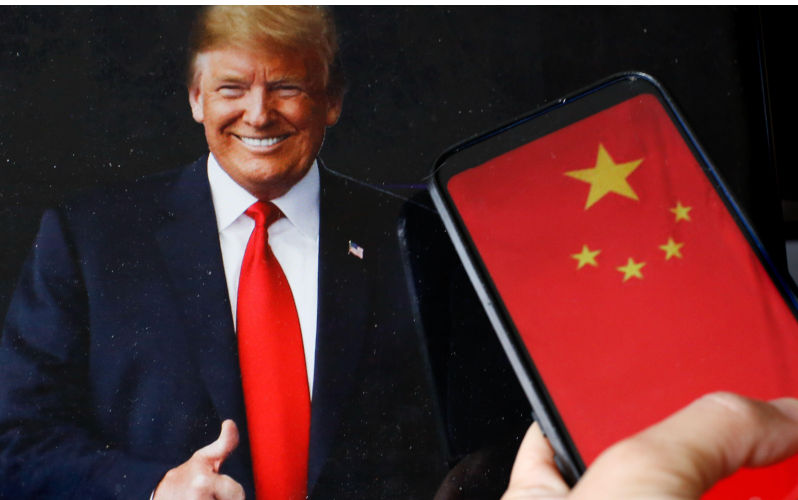 In this photo illustration the US president Donald Trump portrait and a sign 'Tariffs' is shown on a computer screen against a Chinese national flag displayed on a mobile phone screen as the US and China administration agreed to reduce tariffs for a period of 90 days - May 12, 2025. Alamy. Contributor: Dominika Zarzycka Image ID: 3BANA9H How Trump’s vision of a single-minded China containment has failed