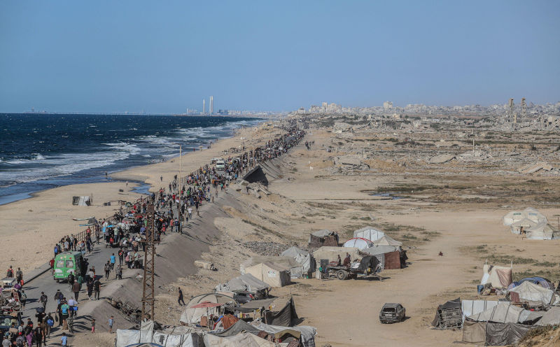 Palestine. 10th Oct, 2025. Palestinians walk along alRashid Street, the main coastal road connecting southern and central Gaza to the north, as they return to their homes following the new ceasefire agreement between Israel and the Palestinian group Hamas in Gaza City, Gaza, on October 10, 2025. Photo by Ramez Habboub/ABACAPRESS.COM Credit Abaca Press/Alamy Live News. ContributorAbaca Press. Image ID3CWCCTA Gaza has a ceasefire, now Palestine needs self-determination