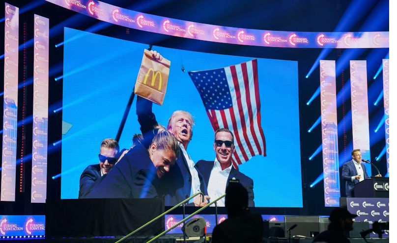 Supporters of U.S. Republican presidential candidate Donald Trump watch as a McDonald's meme is shown during a campaign rally at Gas South Arena on October 23, 2024 in Duluth, Georgia, USA. (Photo by Julia Beverly/Alamy Live News). Contributor: Julia Beverly Image ID: 2YWP7WP How’s my lippy? Polishing up impression management and memes