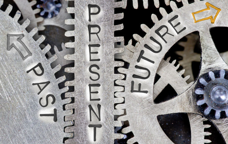 Macro photo of tooth wheel mechanism with arrows and PAST, PRESENT and FUTURE words imprinted on metal surface. Image: iStock / EtiAmmos Economic reform must included industrial transformation - Part 1