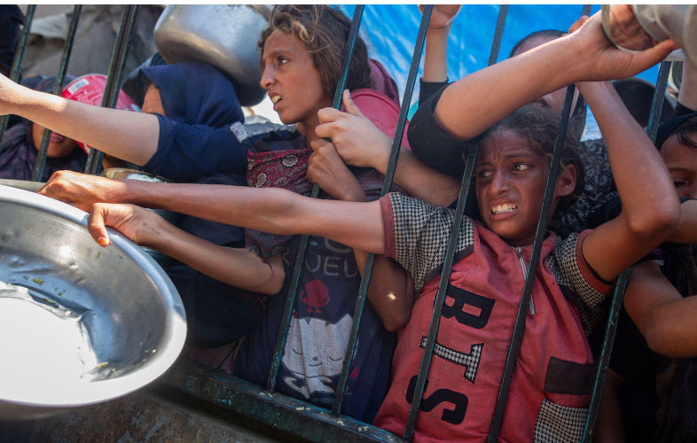 Displaced Palestinians collect donated food in Khan Yunis camp, southern Gaza. Contributor: jehad alshrafi / Alamy Stock Photo Image ID: 2Y1E2RK Starvation of Gaza a continuation of a decades-old plan