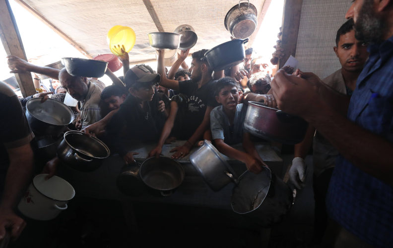Palestinians wait for food at a distribution point in Gaza City Palestinians wait for food at a distribution point in Gaza City, on June 14, 2025. Israel has faced growing condemnation over the humanitarian crisis in the war-ravaged Gaza Strip, where the United Nations has warned the entire population faces the risk of famine after no aid was allowed to enter for more than two months. Photo by Omar Ashtawy apaimages Gaza city Gaza Strip Palestinian Territory 140625_Gaza_OSH_3_0021 Copyright: xapaimagesxOmarxAshtawyxxapaimagesx. Contributor: Imago Image ID: 3BJEP3E The disgrace of deliberate starvation: Israel's war of hunger in Gaza