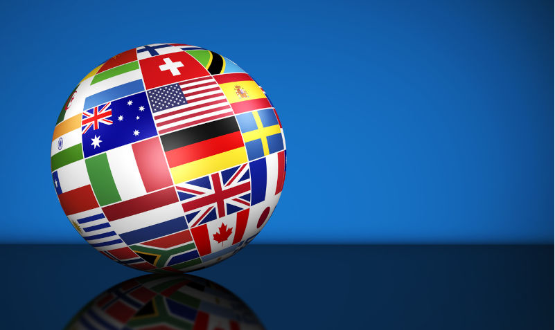 Globe and international flags of the world on blue background with copy space. Image: iStock / NiroDesign Australia should use its power as an independent voice to push for peace