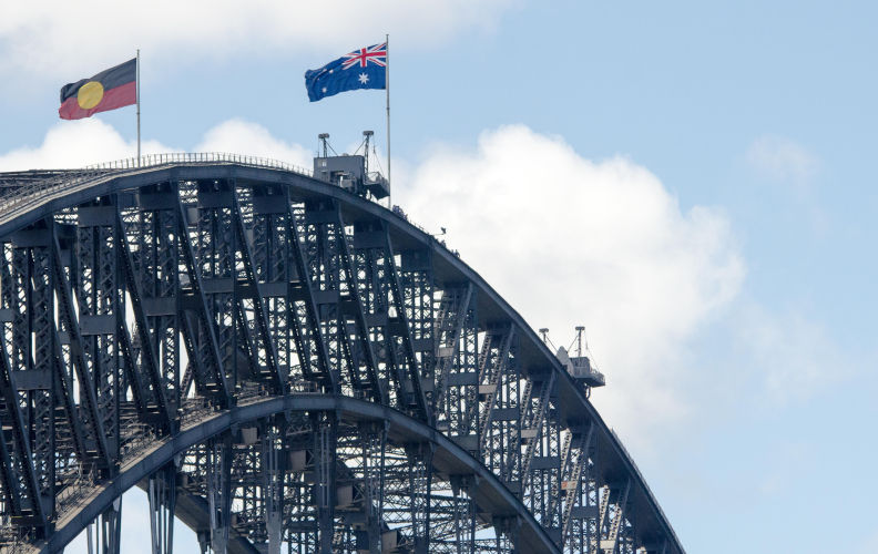 Sydney, Australia - 26th January 2016: Australia Day celebrated in the Rocks, Sydney. An aboriginal flag seen raised on the Sydney Harbour Bridge. This was able to be viewed from multiple locations including The Rocks. Credit: mjmediabox/Alamy Live News Contributor: mjmediabox / Alamy Stock Photo Image ID: FD0CD9 Sydney Harbour Bridge walk – unsuspected joy and hope