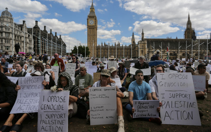 Protesters gather holding placards saying 'I oppose genocide. I support Palestine Action' during the demonstration. Following the Home Secretary's order to proscribe Palestine Action as a terrorist organisation, over 500 supporters organised by Defend Our Juriesgatheredr to sit down in Parliament Square holding signs saying, 'I oppose genocide. I support Palestine Action' and dared the police to arrest them all. Image:AAP/ Martin Pope / SOPA Images/Sipa USA Hundreds arrested in London for opposing ban on nonviolent group Palestine Action