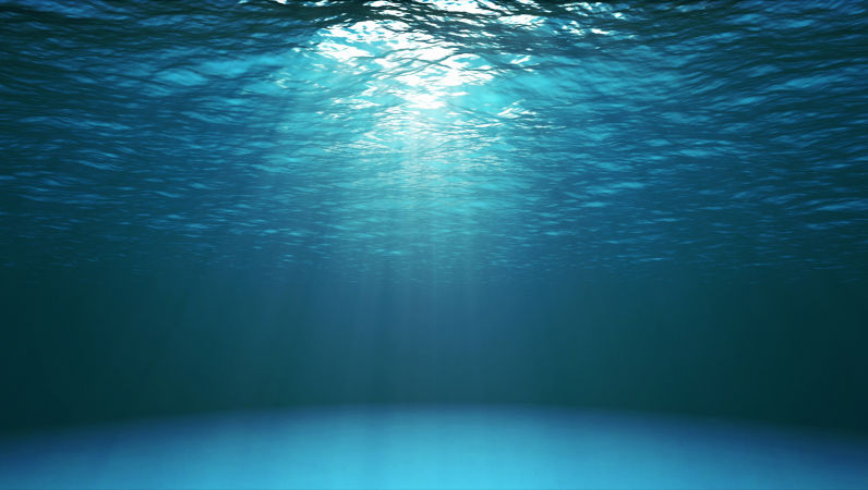 Dark blue ocean surface seen from underwater. Abstract waves underwater and rays of sunlight shining through. Image: Istock / katatonia82 Environment: Will Labor now protect our environment? If not now, probably never