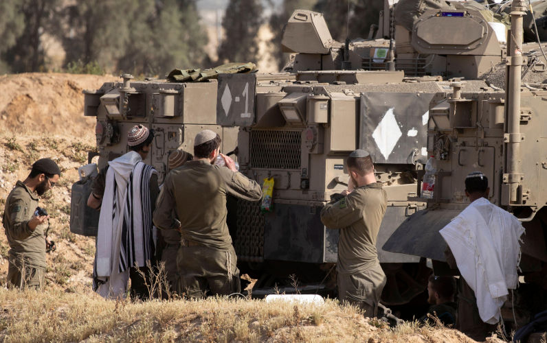Southern Israel, Israel. 03rd Apr, 2025. Israeli solders at their armoured personnel carrier (APCs) during morning prayers inside southern Israel at a staging area along the southern Gaza Strip border on April 3, 2025. Israel has increased fighting in southern Gaza Strip as they increase the security zones inside the Gaza Strip in a bid to increase pressure on Hamas to releasee the Israeli hostages held since October 7, 2023. Photo by Jim Hollander/UPI Credit: UPI/Alamy Live News. Contributor: UPI / Alamy Stock Photo Image ID: 3AC8WN9 IDF actions in Gaza directly contradict Jewish ethical tradition