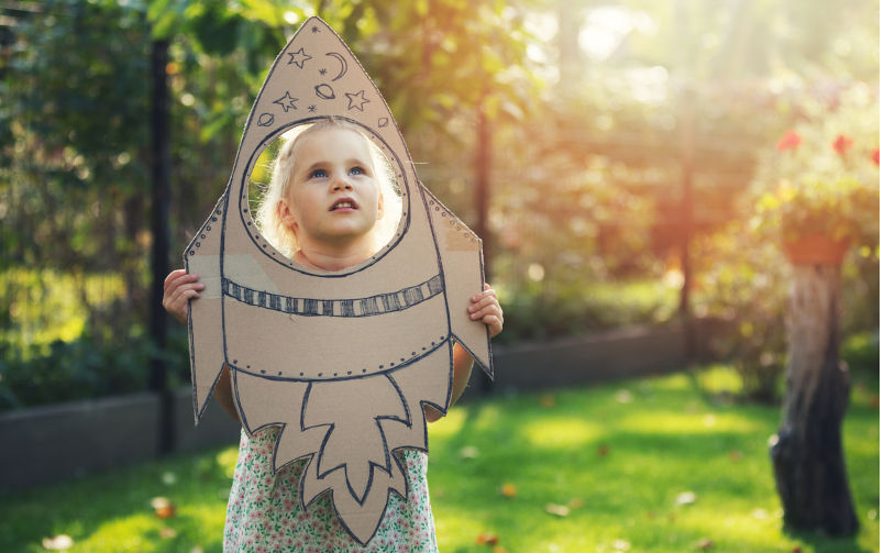 Little girl with cardboard rocket dreaming about stars. concept. Image: iStock / ronstik The gardens of the starships