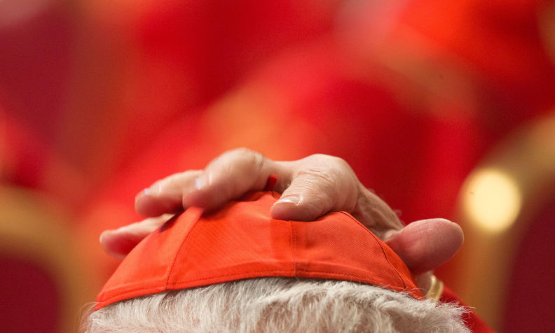 A cardinal puts on his pileolus during the religious mass 'Pro Eligendo Romano Pontifice' at Saint Peter's Basilica in the Vatican, Vatican City, 12 March 2013. The Catholic Church's 115 cardinal electors are taking part in a mass in St. Peter's Basilica on 12 March ahead of entering the conclave for a papal election that observers say has no clear favourite. The Pro Eligendo Romano Pontefice ('For the Election of the Roman Pontiff') mass is presided by Angelo Sodano, the elderly dean of the College of Cardinals, and is also open to non-voting cardinals - those aged more than 80. The next pope. Contributor: dpa picture alliance / Alamy Stock Photo Image ID: D4CYT8 Will the new pope be a Francis clone?