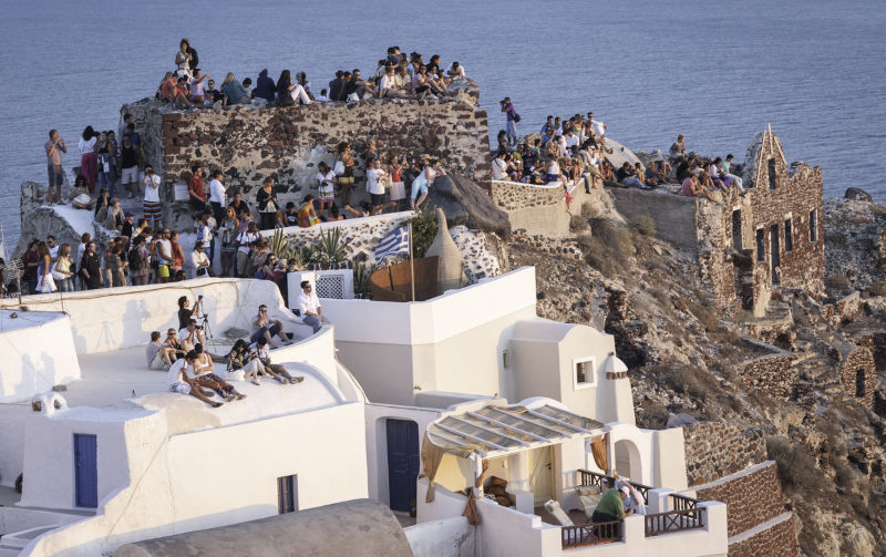 View of the Castle on the caldera of Oia in Santorini. Crowds of people perched on the half-ruined Castle. Image:iStock/Angelos-Mihas Anti-tourism protests are not new. They happened in ancient Rome, 19th-century England and after World War II