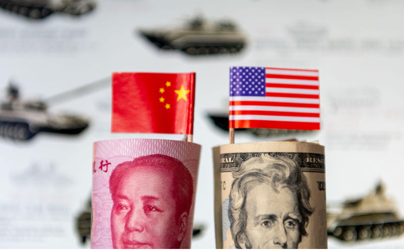A roll of USD and Chinese Yuan with each country's national flags in front of a military background. A military spending, competition, arms race. Contributor: Yau Ming Low / Alamy Stock Photo Image ID: 2RCY3B1 US unlikely to be able to hold its own against China