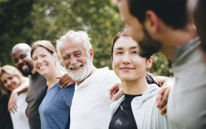 Happy diverse people together in the park. Image iStock / CreditRawpixel The key to social cohesion