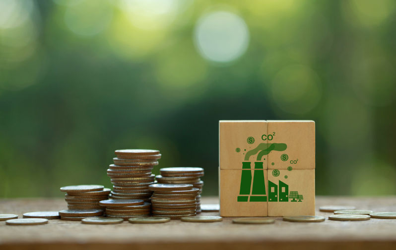Coins stack with CO2 icons on wooden cubes for Environmental and social responsibility businesses. Image: iStock / pcess609 Economists want a carbon price comeback – but does Australia have the political courage?
