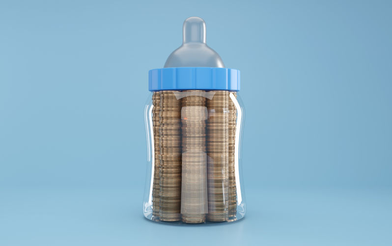 Baby milk bottle filled with gold coins in light blue background. Illustration of the concept . Image iStock / CreditDragon Claws Boosting equity and safety for Australia's children