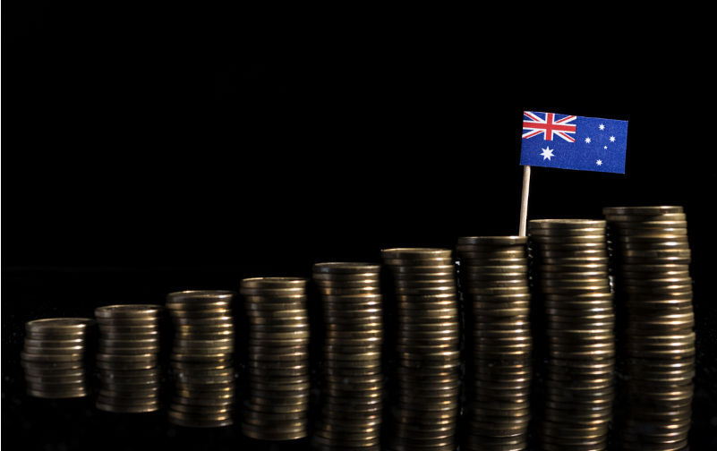 Australian flag with lot of coins isolated on black background. Image: iStock / Golden_Brown Bringing government back – but not all the way