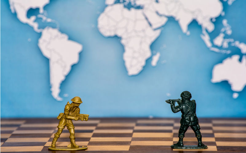 Variety of plastic toy soldiers standing on a chess Board. Soldiers of different colours. Image: iStock / :Discha-AS 'Total war'