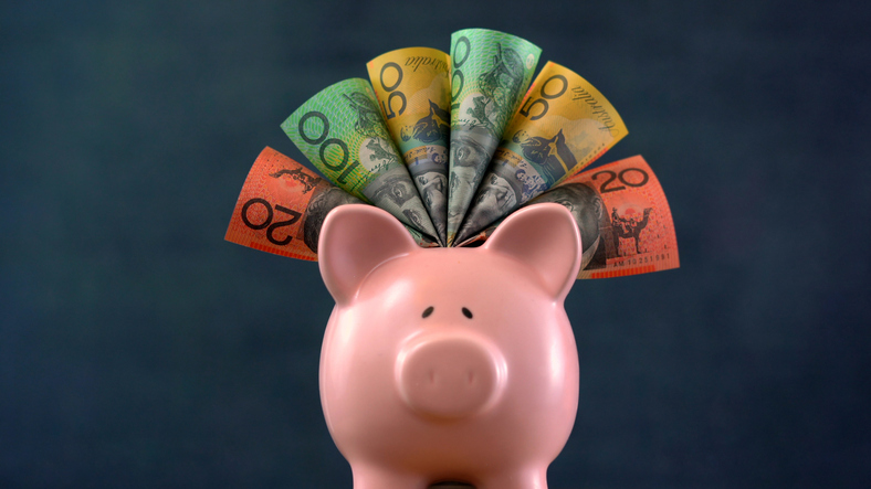 Pink Piggy bank money concept on dark blue background, stuffed with Australian cash. Image: iStock/MillefloreImages The superannuation system matures at 12% of wages