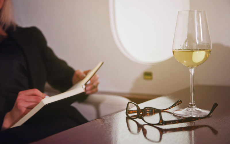 Businesswoman working on laptop in private jet. Image:iStock/Aleksandr-Golubev 'Indefensible': Trump budget law subsidises private jet owners while taking healthcare from millions