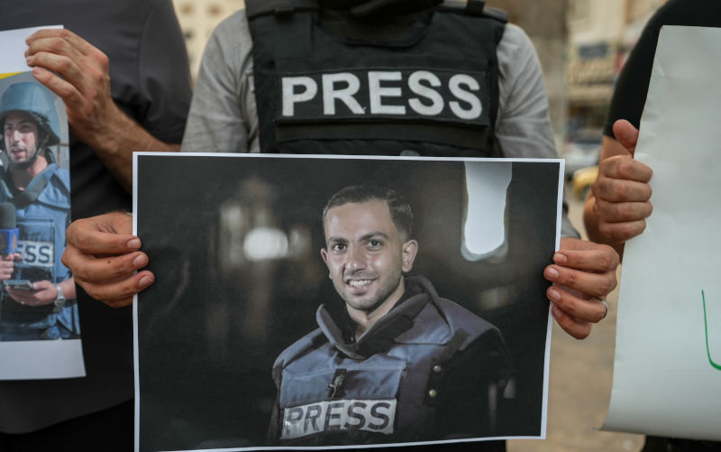 A Syrian journalist holds a picture of late Palestinian journalist and Al Jazeera correspondent Anas al-Sharif during a protest against the killing of journalists in the Gaza Strip, in Idlib, northwestern Syria, 11 August 2025. At least seven people, including five members of the Al Jazeera team, were killed in an Israeli strike on their tent outside Gaza's Al-Shifa Hospital late 10 August 2025. Israel's military claimed direct responsibility for the attack. EPA/AHMAD FALLAHA/ AAP Tributes, condemnation pour in over slain Al Jazeera journalists in Gaza