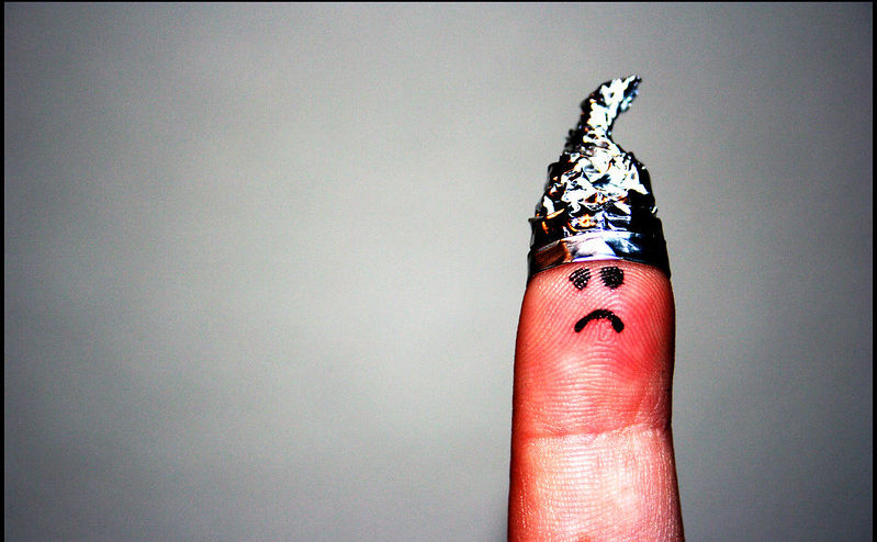 A finger puppet in a tin foil hat