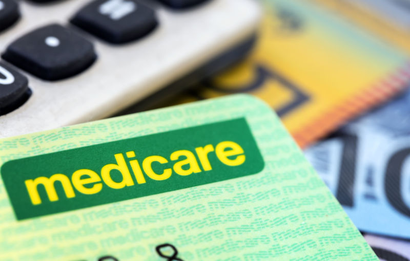 Australian Medicare card with calculator and cash background