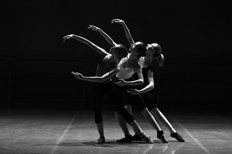 Ballerinas performing on a darkened stage