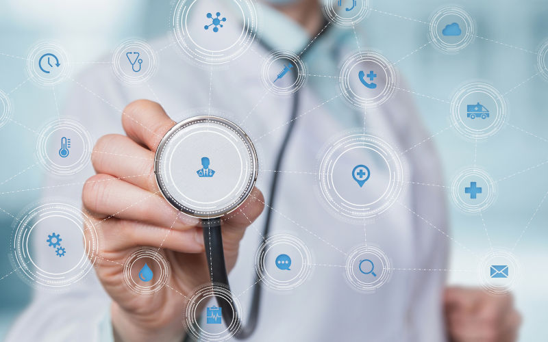 A doctor holding a stethoscope to the elements of health care