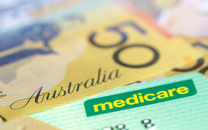 Medicare card next to $50 bills