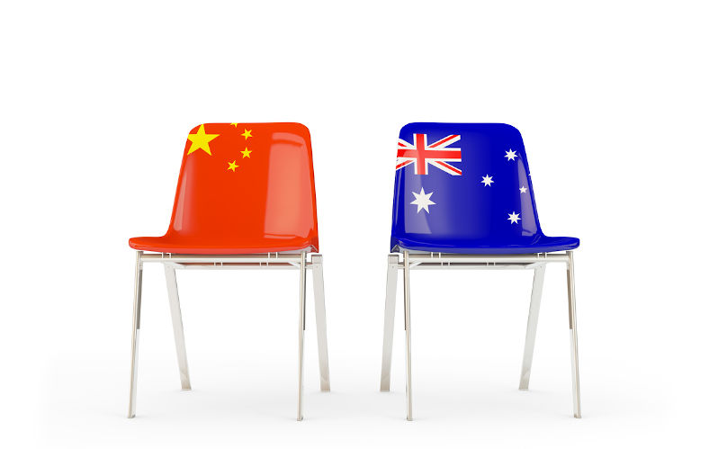 Two chairs with flags of China and Australia isolated on white