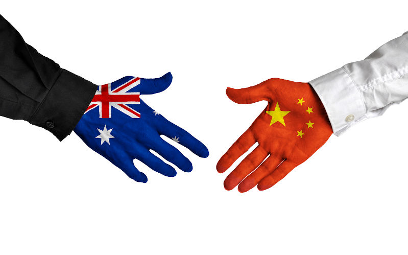 Australia and China painted shaking hands in agreement