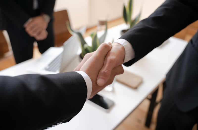 Shallow Focus of Two People Handshaking