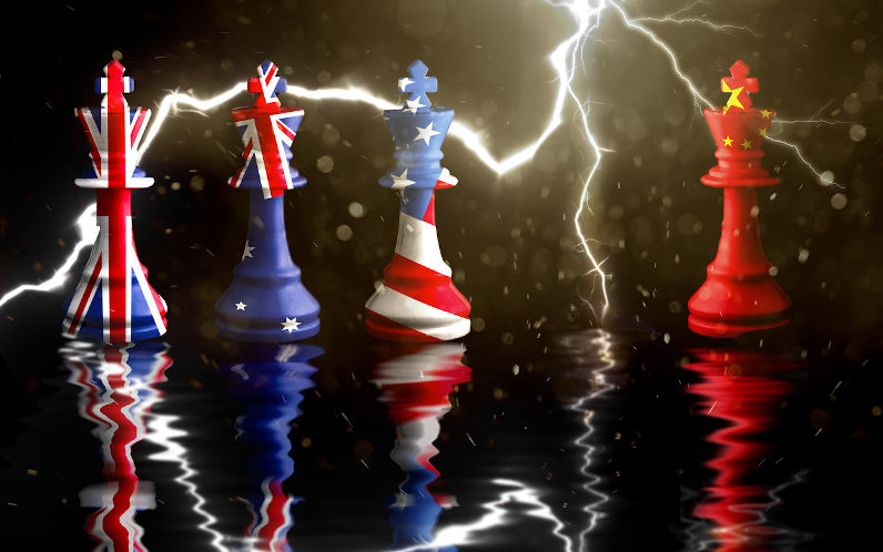 AUKUS pact represented in chess pieces painted in the flags of each country, grouped together, while the China chess piece stands apart. Dark background with lightning