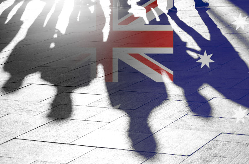 Australian Flag as Background and Silhouettes of People