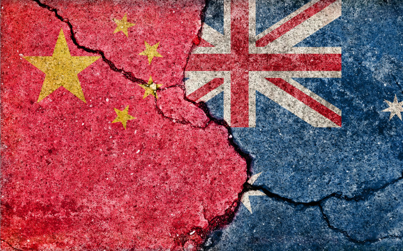 China and Australian flags on cracked background