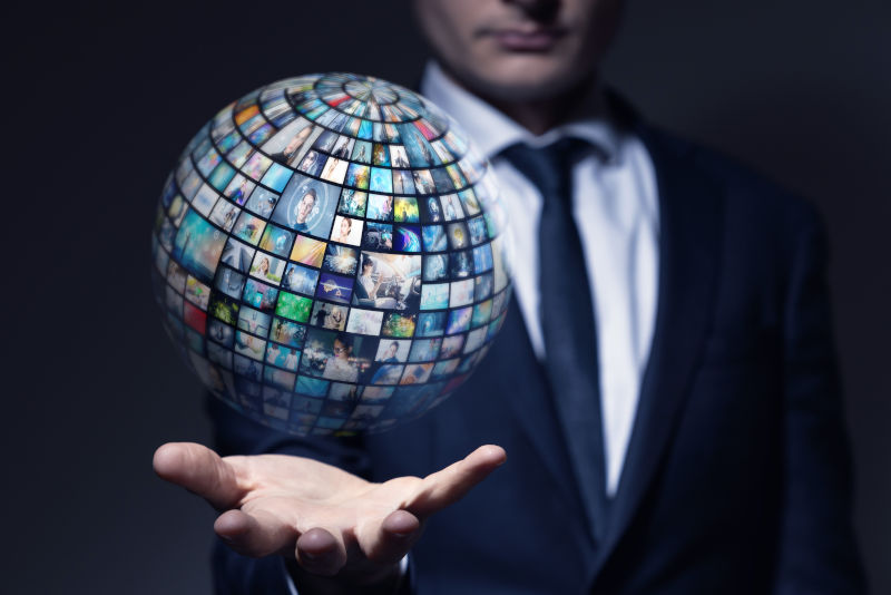 Media archives concept man holding media globe