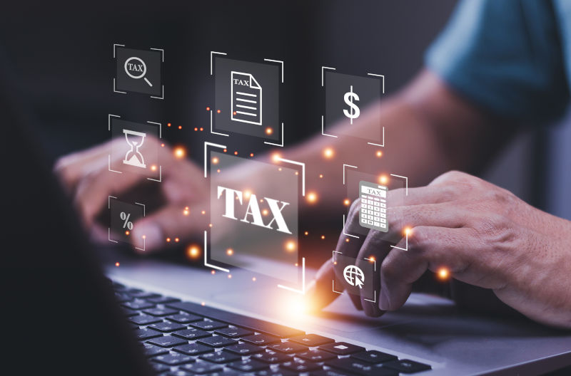 Digital tax forms and symbols holographed from a computer screen