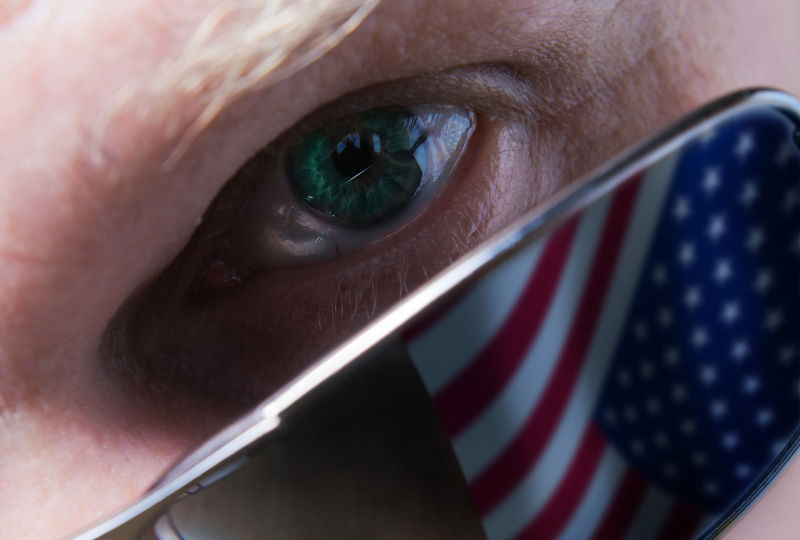 The person in dark glasses attentively looking at you USA flag reflection in glasses