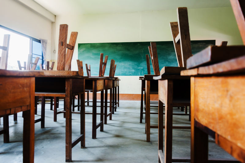 chair and table in class room with black board background,