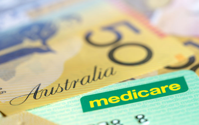 Australian Medicare Card over Money. Shallow focus, with copy space.