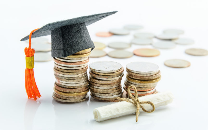 Coins and cash, a black graduation cap, a certificate