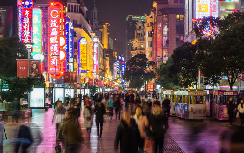 Alt text is Crowd in Nanjing Road in Shanghai. Image: iStock.