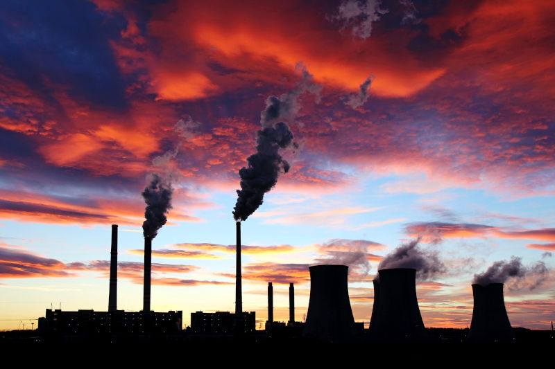 Dramatic sunset on the sky and coal power plant factory