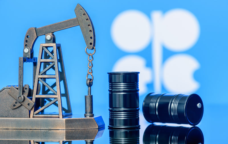 Petroleum, petrodollar and crude oil concept : Pump jack and flag of OPEC.