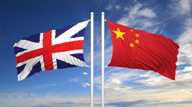 UK and Chinese flags against blue sky