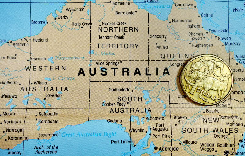 Australia dollar coin on map.