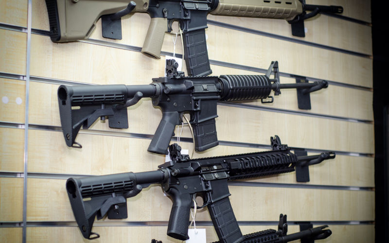 Gun wall rack with rifles.